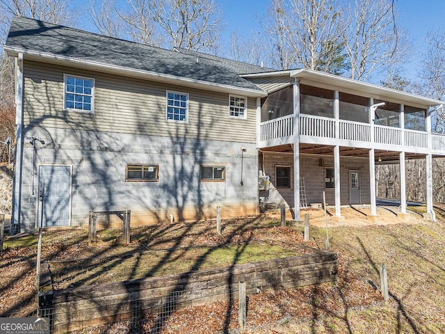 rear view of house with a patio area and a sunroom