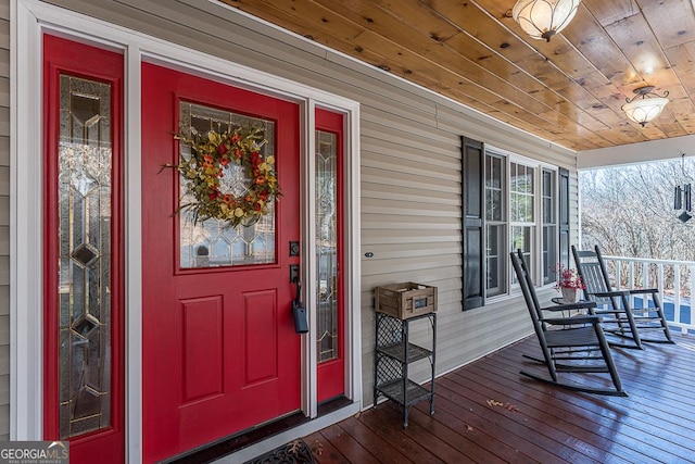 view of exterior entry with covered porch