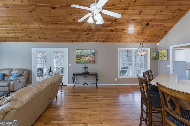 dining area featuring vaulted ceiling, wood ceiling, french doors, and light hardwood / wood-style flooring