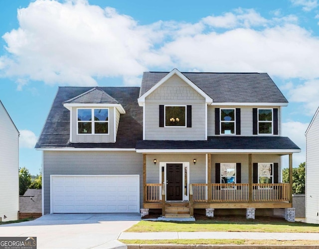 view of front of home with covered porch and a garage