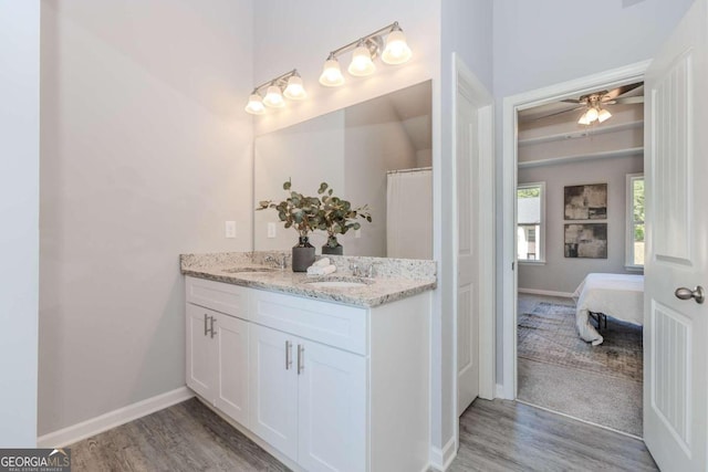 bathroom with vanity, hardwood / wood-style flooring, and ceiling fan