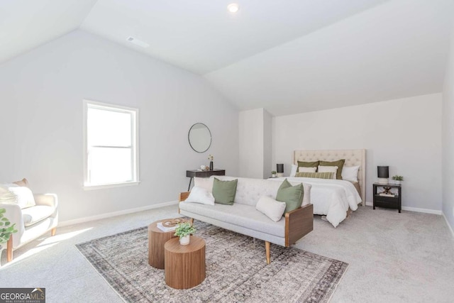 bedroom featuring lofted ceiling and light carpet