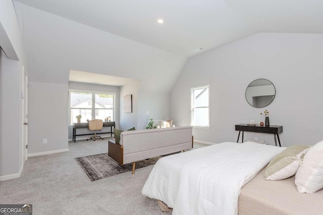 bedroom with lofted ceiling and light colored carpet