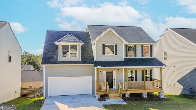 view of front of home featuring a porch, a front yard, and a garage