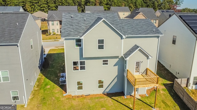 rear view of property featuring a yard