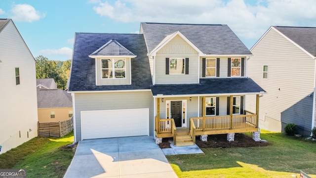 view of front of property with a garage, a front lawn, and a porch