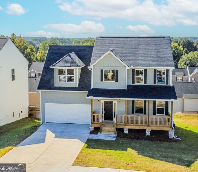 view of front of property featuring a porch, a front yard, and a garage