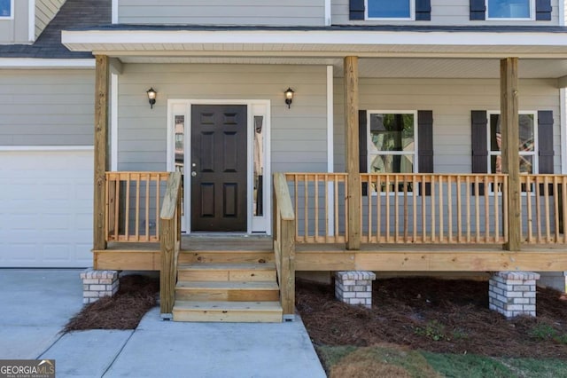 view of exterior entry with covered porch