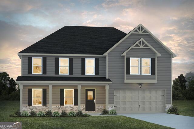 view of front of house with a garage and a lawn