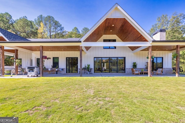 rear view of house with a patio and a lawn