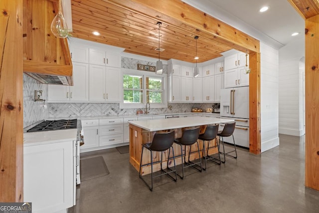 kitchen featuring white cabinetry, sink, a center island, and high end fridge