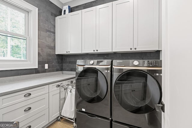 laundry area featuring cabinets and independent washer and dryer