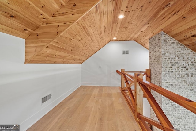 bonus room featuring lofted ceiling, wooden ceiling, and light hardwood / wood-style floors