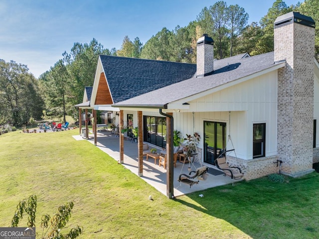 back of house featuring a patio and a lawn