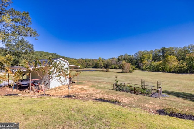 view of yard featuring a carport and a rural view