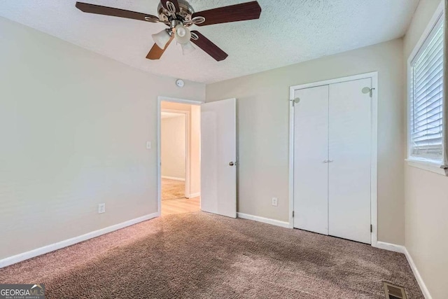 4660 Edwina Ln SW, Atlanta, GA 30331 - unfurnished bedroom with carpet floors, a closet, baseboards, a ceiling fan, and a textured ceiling
