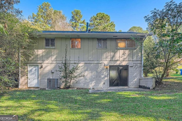 rear view of house featuring a yard and cooling unit