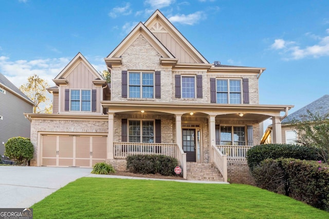 craftsman-style home featuring covered porch, a front yard, and a garage