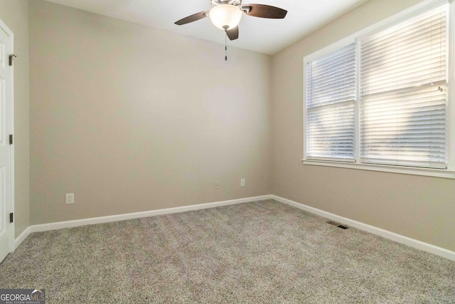 spare room with ceiling fan and carpet floors