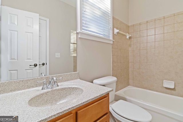 full bathroom featuring vanity, toilet, and tiled shower / bath