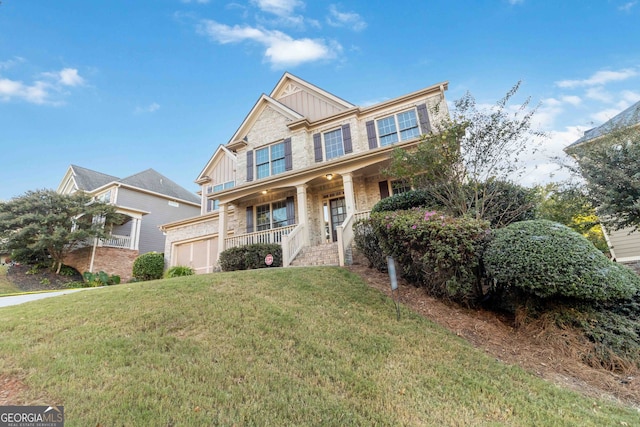 craftsman-style home with a porch, a front lawn, and a garage