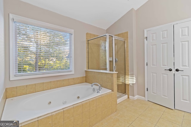 bathroom with separate shower and tub, vaulted ceiling, and tile patterned flooring