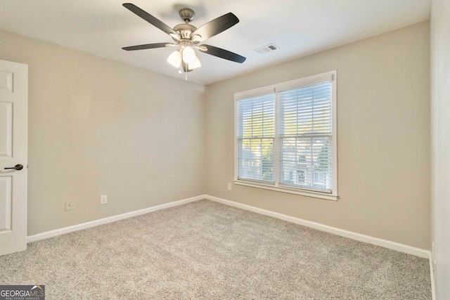 unfurnished room featuring light colored carpet and ceiling fan