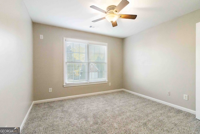 spare room featuring carpet floors and ceiling fan