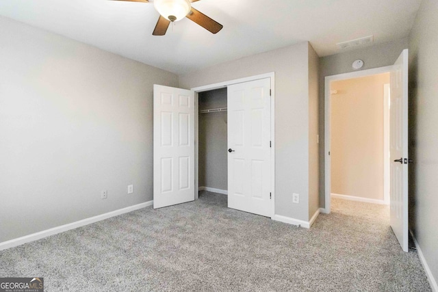 unfurnished bedroom with a closet, ceiling fan, and light carpet