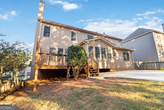 back of property featuring a wooden deck