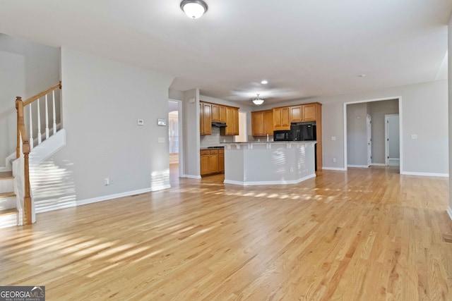 unfurnished living room with light hardwood / wood-style floors