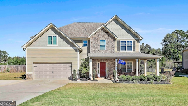 craftsman house with a front yard, a garage, and covered porch