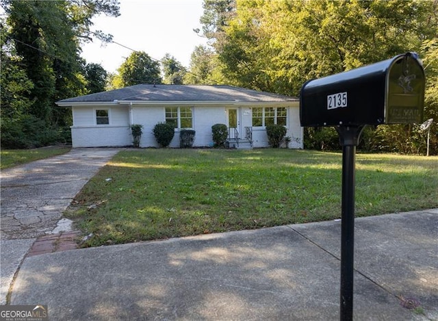 ranch-style house with a front lawn