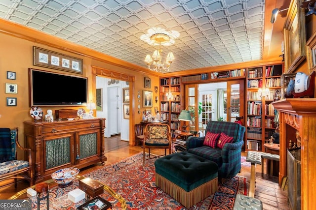 living room with ornamental molding and a chandelier