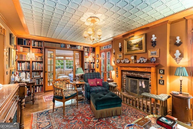 sitting room featuring crown molding, a notable chandelier, and a fireplace