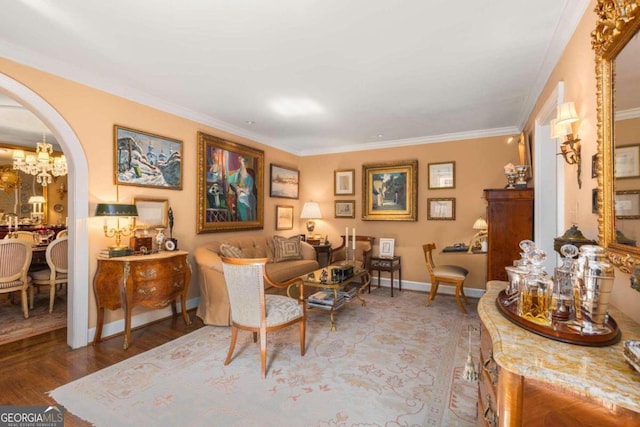 living room featuring ornamental molding, hardwood / wood-style floors, and a notable chandelier