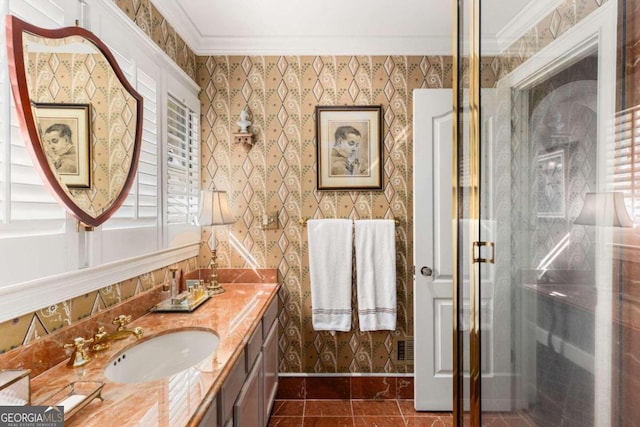 bathroom with vanity, tile patterned floors, ornamental molding, and an enclosed shower