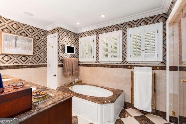 bathroom with tile walls, crown molding, and a tub to relax in