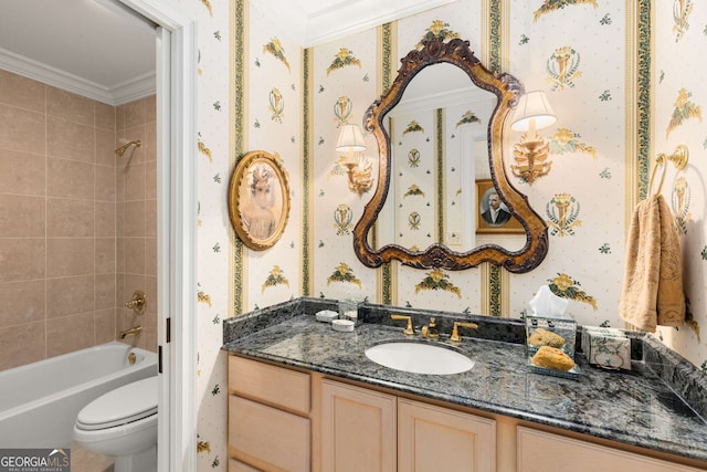 full bathroom featuring toilet, crown molding, vanity, and tiled shower / bath