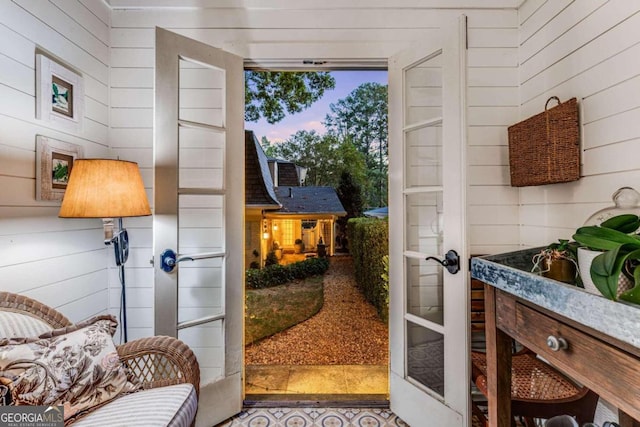 doorway featuring wooden walls