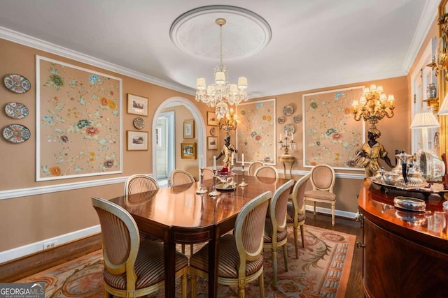 dining area with ornamental molding and dark hardwood / wood-style flooring