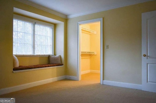 unfurnished room with crown molding and carpet