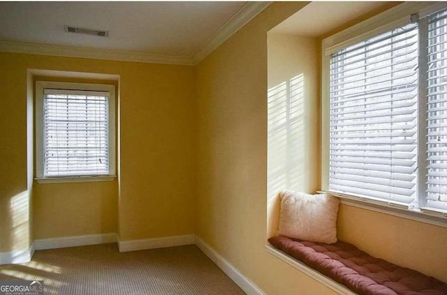 unfurnished room with crown molding, a healthy amount of sunlight, and carpet floors