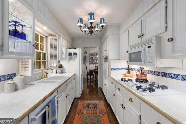 kitchen featuring tile countertops, dark hardwood / wood-style floors, appliances with stainless steel finishes, and white cabinetry