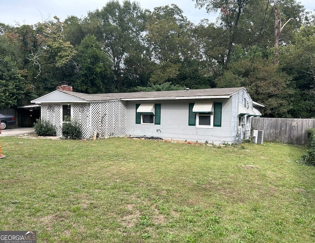 ranch-style home with a front lawn and central air condition unit