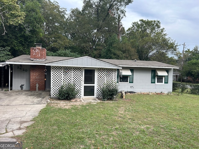 ranch-style home with a front yard and a carport