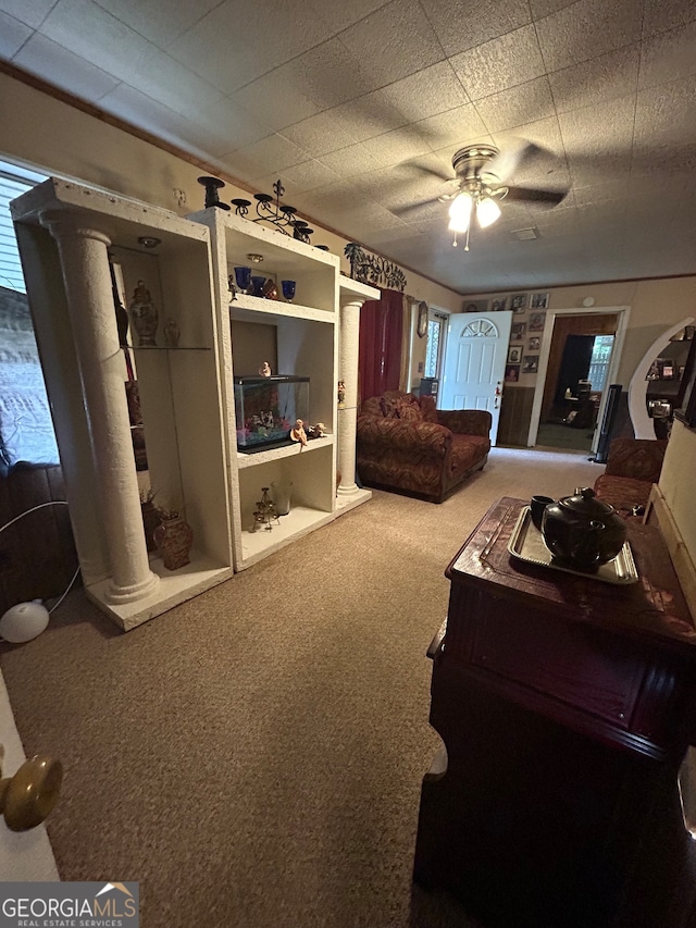 bedroom with decorative columns, ceiling fan, and carpet