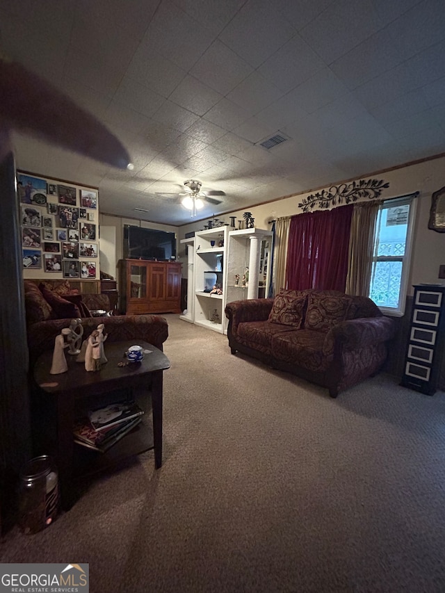 carpeted living room with ceiling fan