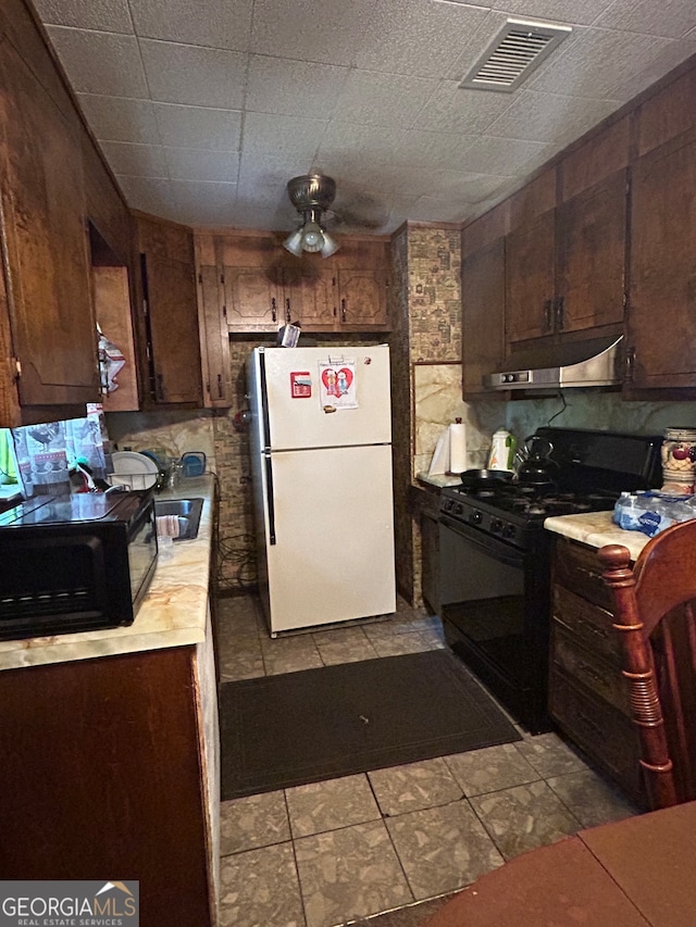 kitchen with tasteful backsplash, black appliances, ceiling fan, dark brown cabinetry, and light tile patterned floors