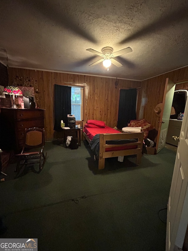 carpeted bedroom with wood walls, a textured ceiling, and ceiling fan